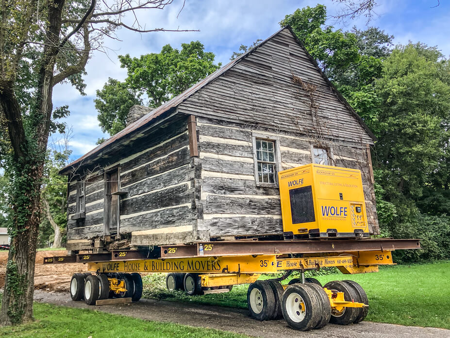 Wolfe relocates log cabin on dollies