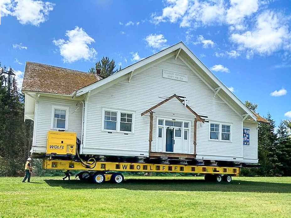 Wolfe foreman drives Carus Schoolhouse through field to new location