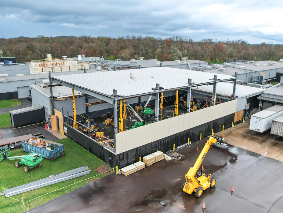Aerial view of Wolfe House Movers lifting 7,500-sq-ft warehouse roof
