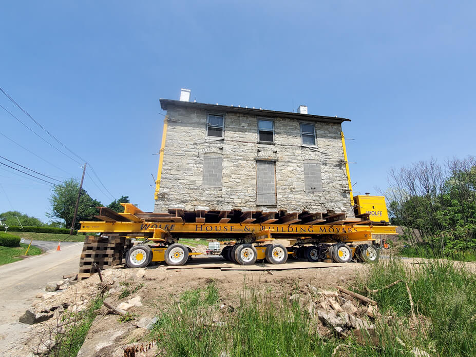 Wolfe moves a historic stone house away from the road