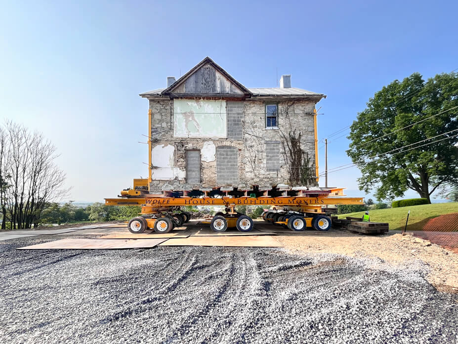 Junkin house rests on dollies over new foundation