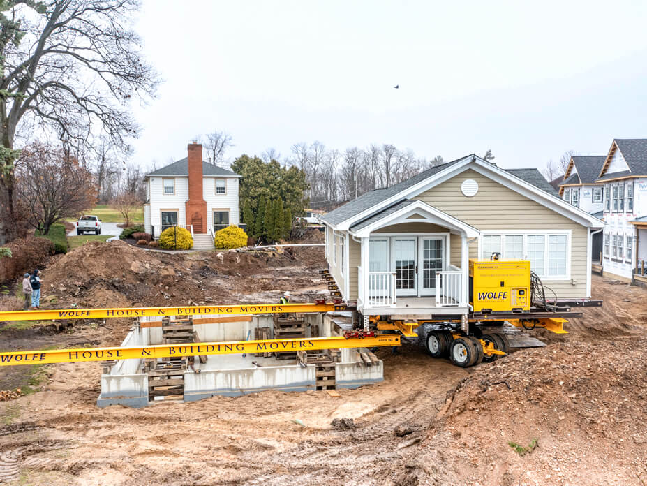 End view of Wolfe House Movers ready to slide lake cottage over new foundation