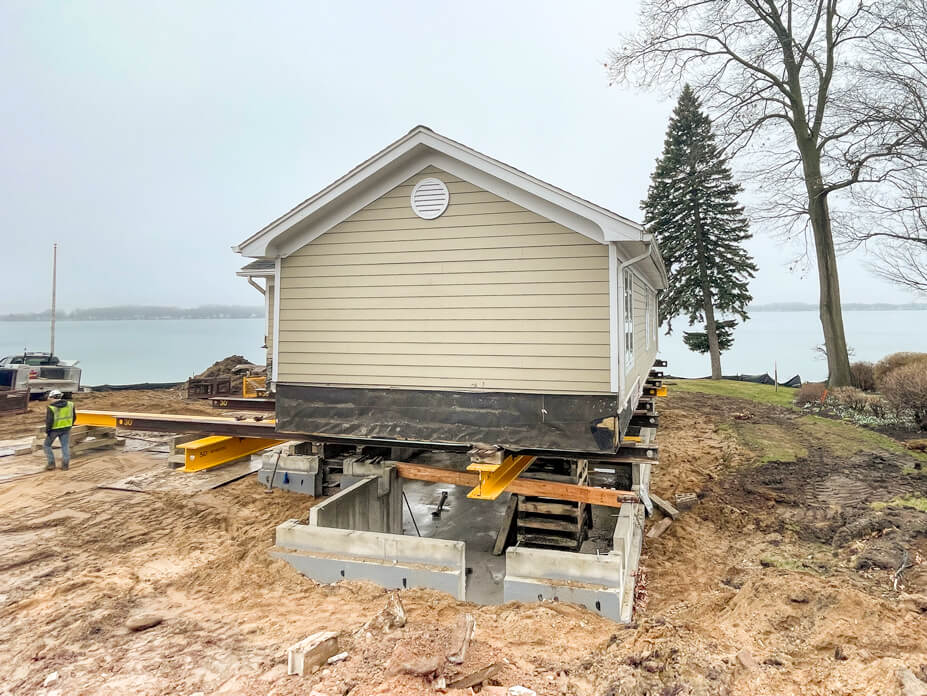 Lake cottage rests on beams and cribbing over new foundation
