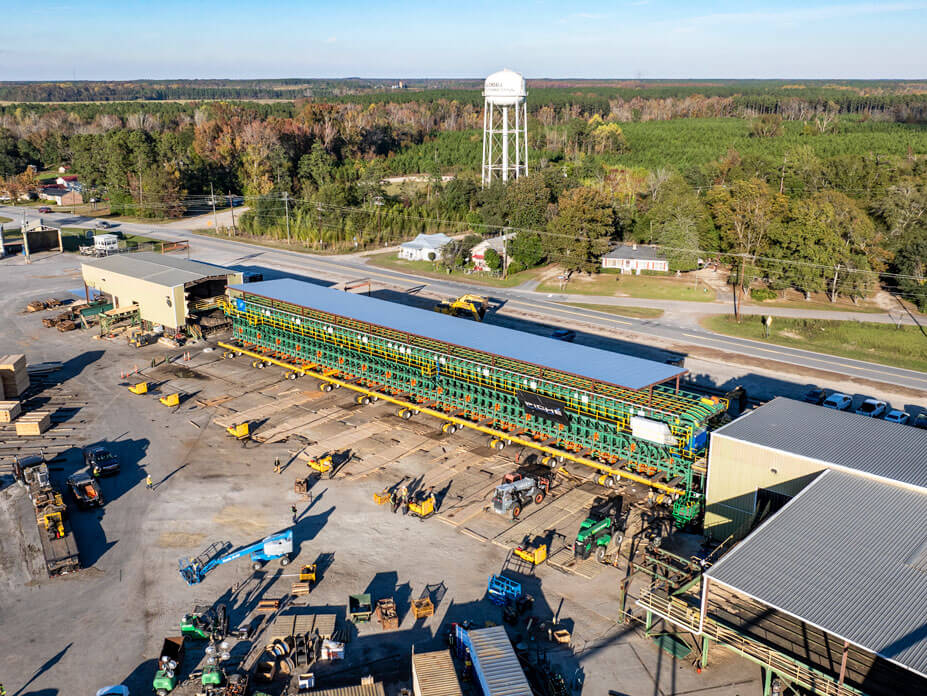 Aerial view of Wolfe sliding a 225' lumber sorter into position at a lumber mill