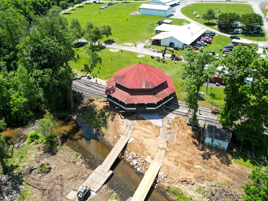 Aerial view of the carousel house with creek and jumper bridges in foreground