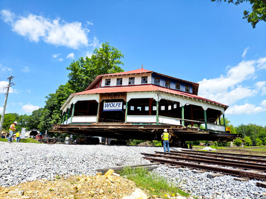 Wolfe personnel drive the carousel house across railroad tracks to the new site