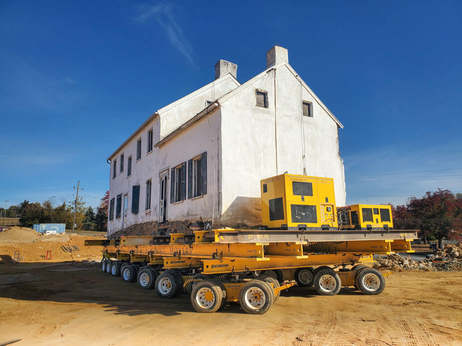 stone house with yellow dollies and power units