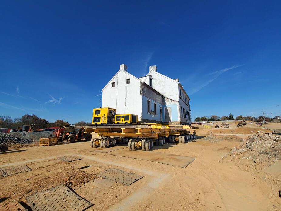 stone house on wheels with new footers in foreground