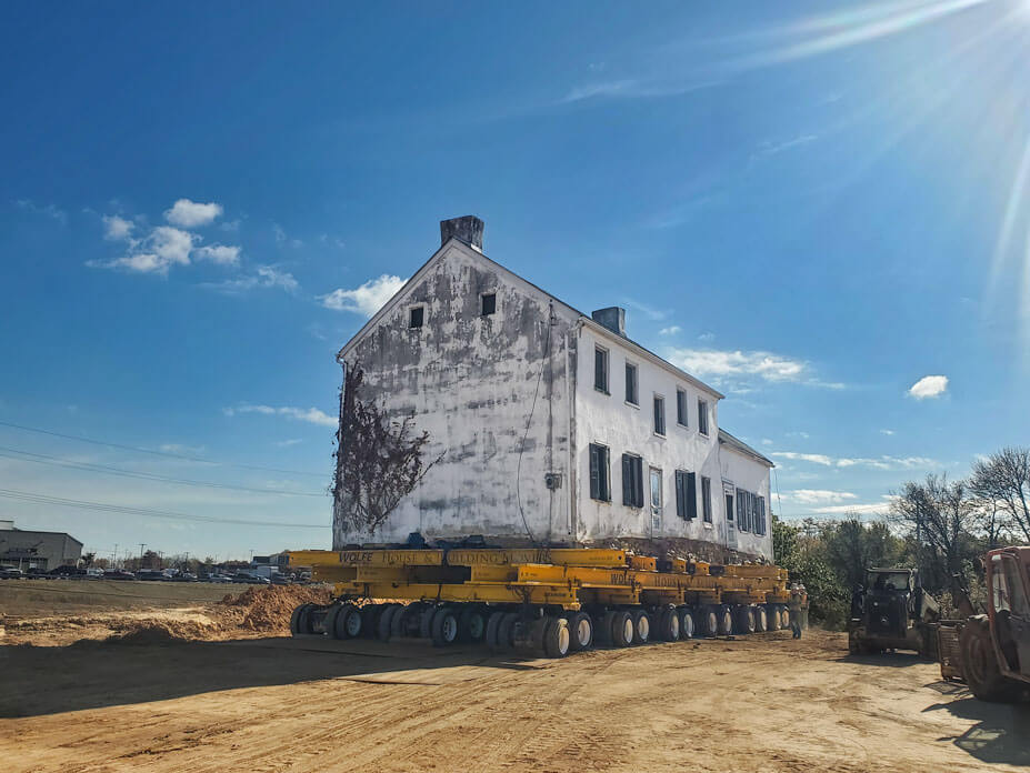 end view of stone house on wheels over new foundation