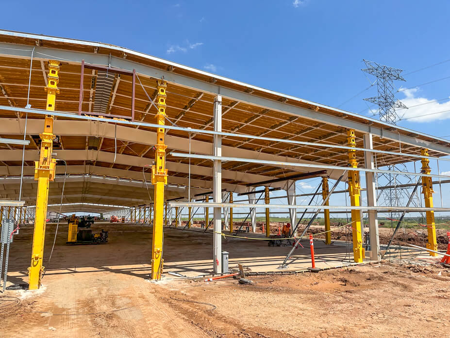 Front facade of warehouse with yellow jacking towers