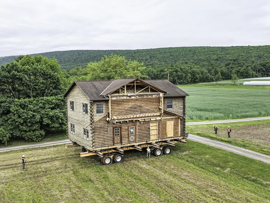 Aerial view of the home on dollies going over a ridge