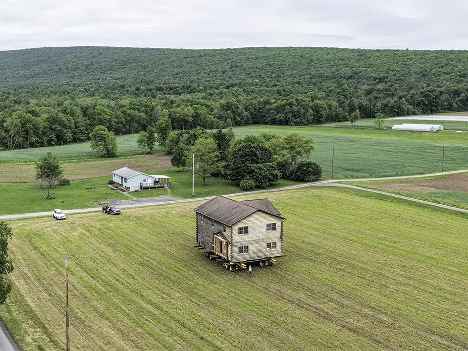 Aerial shot of the home moving through the field