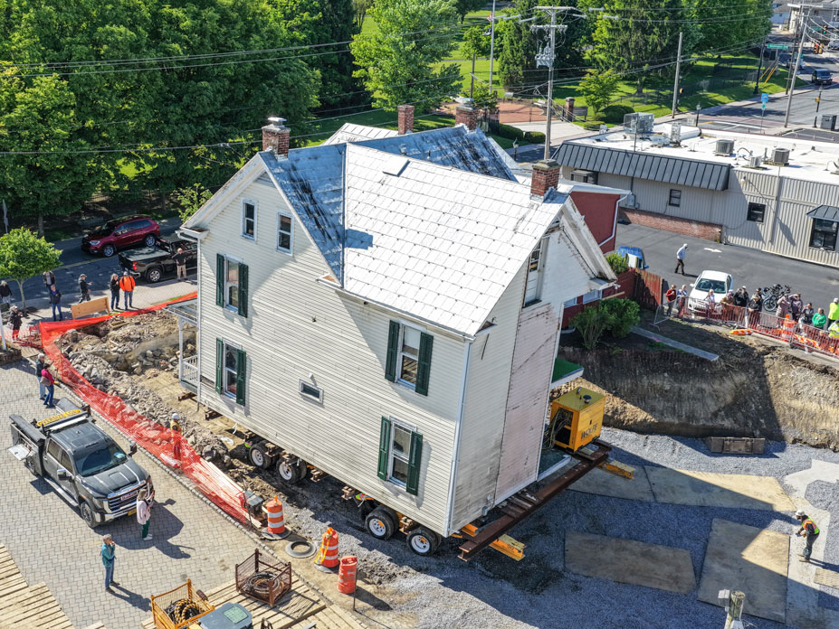 Drone shot of the side of the home moving to its new location.