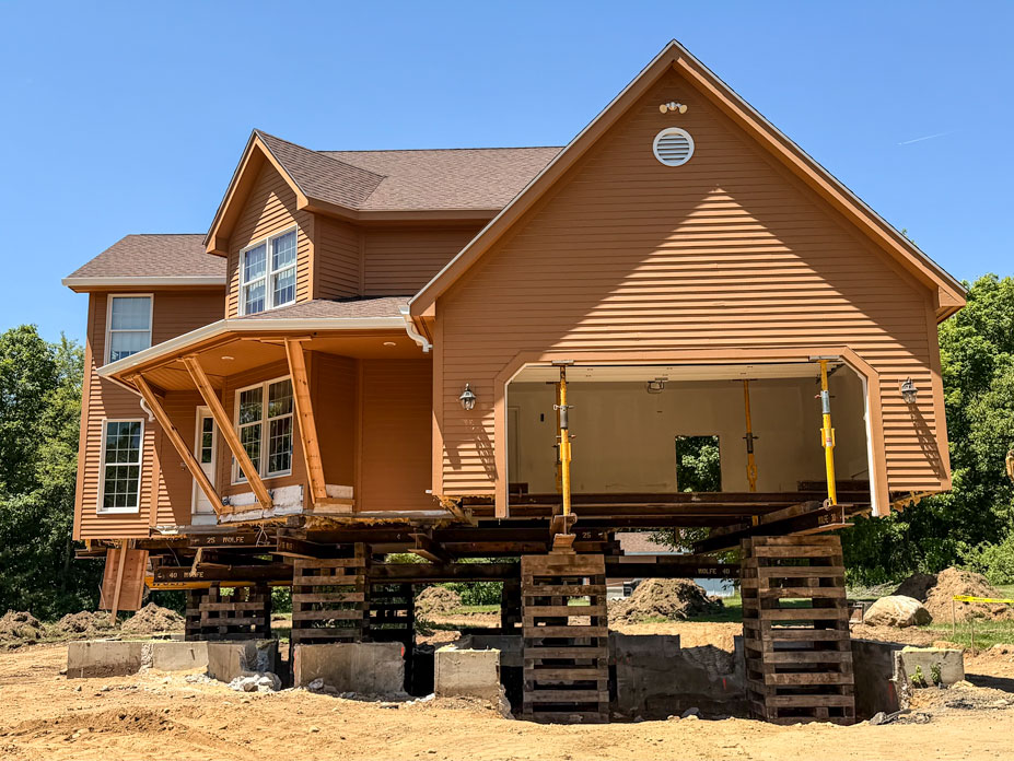 Side view of the home showing the shoring post support on the two car garage